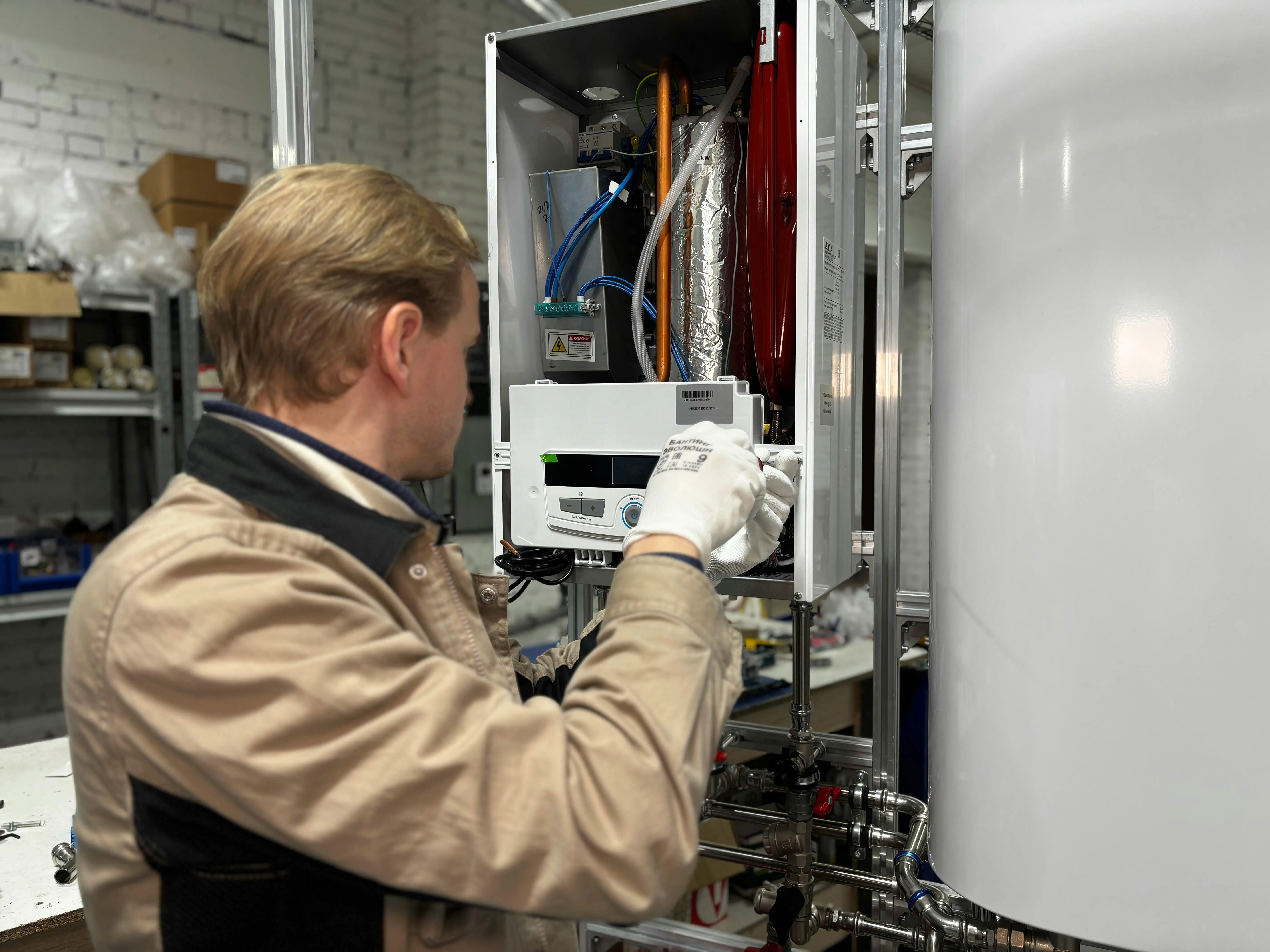 An engineer working inside a heat pump unit during routine maintenance